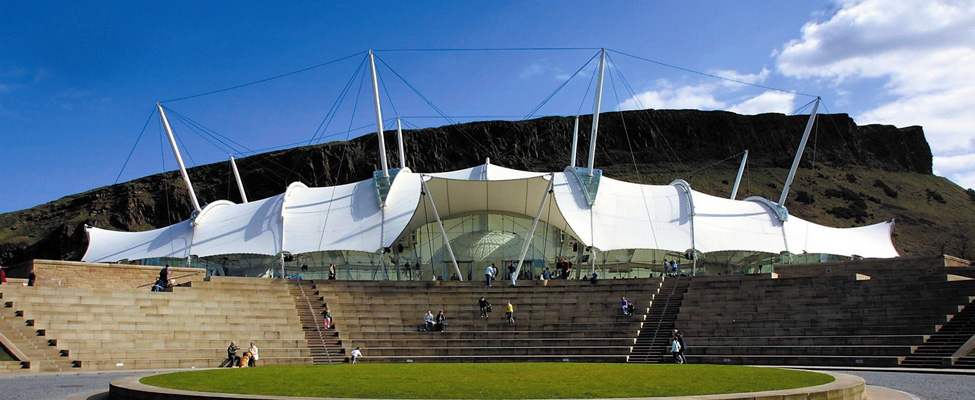 A photo of Dynamic Earth, with Salisbury Crags to the rear