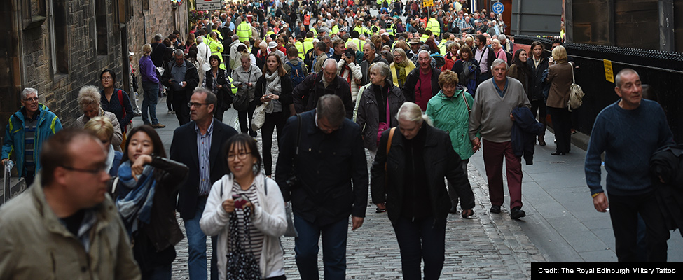 Photo: A crowd of people walking up the cobbled streets of Edinburgh towards the Royal Edinburgh Military Tattoo